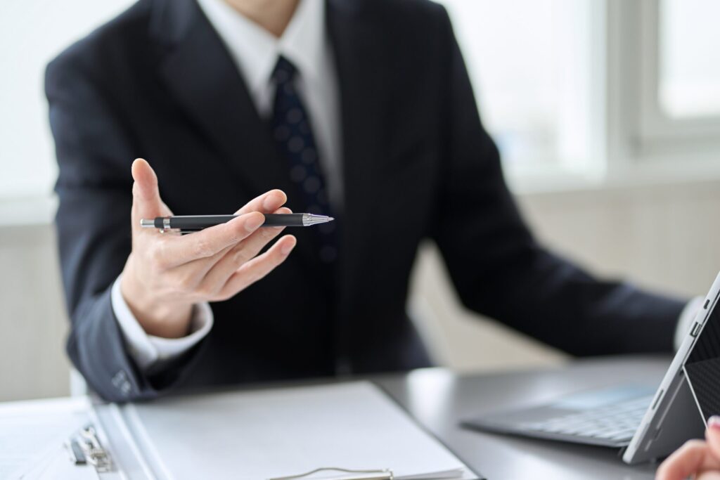 Student signing Dragon Study Tours booking insurance documents before travel to Hua Hin, confirming AXA SmartPlan medical and travel coverage.