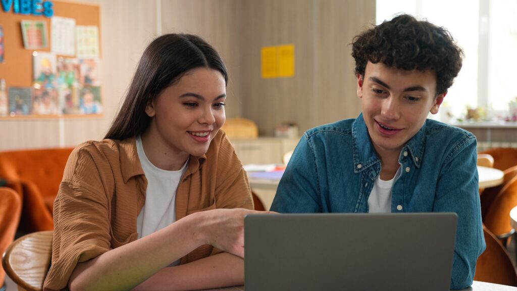 Teenagers studying together on a laptop at a Residential English Camp in Thailand – Spring 2026