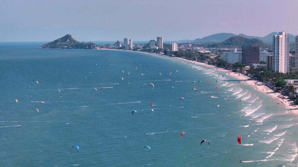 Dragon Student Life Channel 90 Aerial view of Hua Hin’s coastline with kitesurfers, the seaside town where many students come for on-site English learning.
